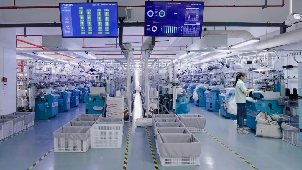 modern sock manufacturing facility with knitting machines and production equipment